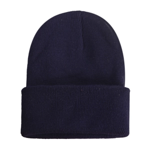 Detail of navy blue knitted beanie showing high-quality ribbed texture and classic cuff