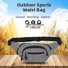 Close-up of grey snakeskin waist bag with multi-zipper pockets on a wooden table