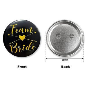 58mm Team Bride tinplate badge with gold glitter font and safety pin back view