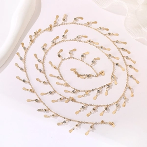 Detailed view of golden link chain with sparkling rhinestones and teardrop sequins