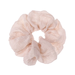 Close-up of pink pleated gauze hair scrunchie showing delicate fabric texture