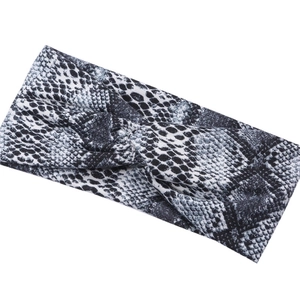 Cross-knot wide sports headband with snake print pattern in black and white elastic fabric