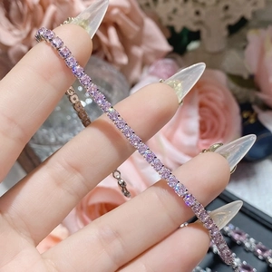 Close-up of pink zircon tennis bracelet with 18K gold plating and round cut stones