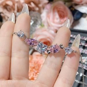 Macro detail of camellia pink gemstone bracelet with 18K gold plated zircon settings