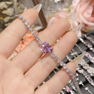 Macro shot of 18K silver-plated bracelet with pink heart gemstone and sparkling zircons