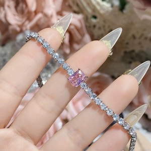 Macro detail of elegant pink gemstone bracelet with sparkling zircons and silver plating