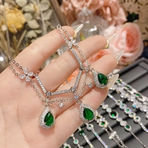 Luxe silver necklace with three pear-cut emerald green gemstones and pavé crystals