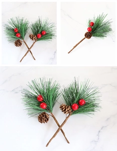 Close-up of Christmas decoration with green pine needles, red berries and natural pine cones
