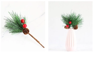 Detail of Christmas pine branches with red berries and pinecones in a pink flower vase