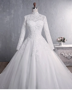 Close-up of high neck lace embroidery and luxury sequins on ivory wedding dress