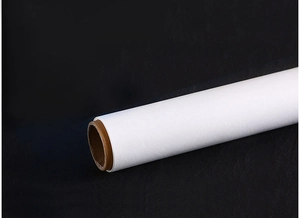 Close-up of a white silicone oil paper roll for baking with a brown paper core on black