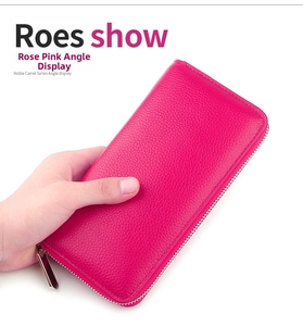 Detail of rose red pebble grain leather long wallet with silver zipper closure