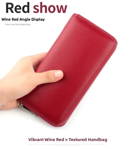 Detail of burgundy lychee grain leather wallet featuring a durable silver metal zipper closure