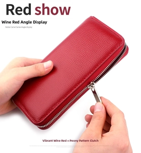 Detail of burgundy lychee grain leather wallet showing silver zipper and hand-held size