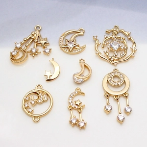 Detail of gold moon and star pendants with inlaid cubic zirconia for jewelry making