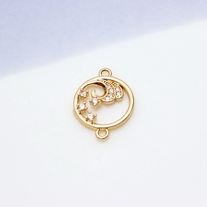 Detailed view of a gold circular charm with wavy zircon inlays and double connector rings
