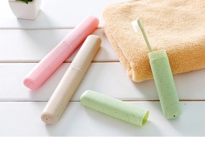 Detail of portable eco-friendly wheat straw toothbrush cases in pink, beige and green