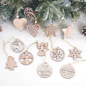 Assorted wooden Christmas ornaments featuring stars, snowflakes and trees on white texture