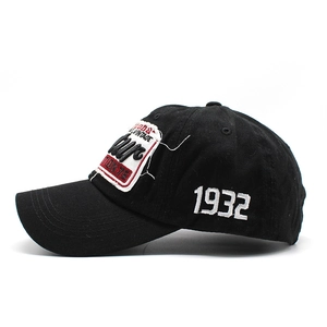 Detail view of black vintage baseball cap featuring white 1932 embroidery and distressed patch