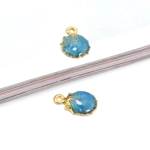 Blue seashell charms with gold alloy edges and sparkling green glitter for DIY jewelry