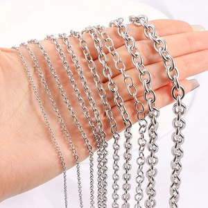 Various sizes of gold and silver stainless steel oval link chains held by hand