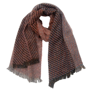 Detailed view of orange and blue herringbone knit pattern scarf with fringe tassels