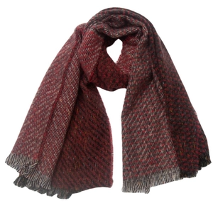 Detail of red and grey checkered winter scarf showing soft fiber texture and tassels