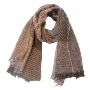 Detailed close-up of patchwork tweed scarf featuring brown tones and soft fringe edges