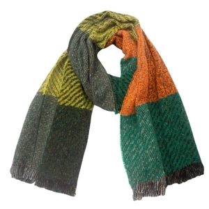 Detail of multicolored plaid knit scarf with classic fringe edges on white background