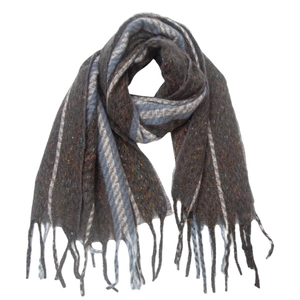 Detailed close-up of knitted scarf with geometric stripes and decorative fringe tassels