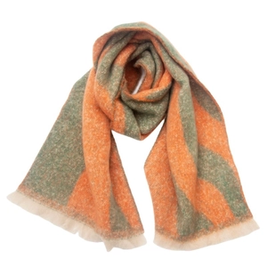 Close-up of orange and green jacquard scarf showing soft texture and fringe tassels