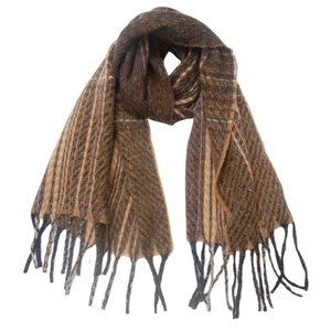 Detail of brown knit scarf featuring mixed stripe patterns and delicate fringe tassels