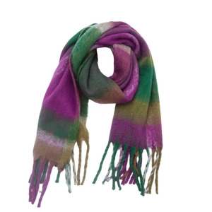 Detail of purple and green plaid bouclé scarf with thick tassels and soft texture
