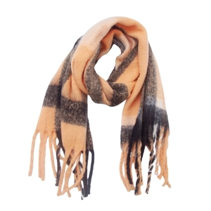 Detail of soft peach and black plaid scarf featuring warm bouclé yarn and fringe trim