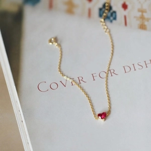 Elegant 14K gold plated S925 silver bracelet featuring a red heart-shaped gemstone
