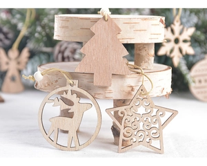 Close-up of laser-cut wooden Christmas ornaments with snowflake and reindeer patterns