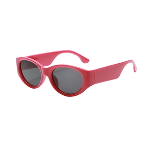 Stylish oval cat-eye sunglasses with pink frames and grey lenses in retro millennial style