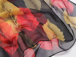 Close-up of lightweight black chiffon scarf with vibrant colorful maple leaf prints