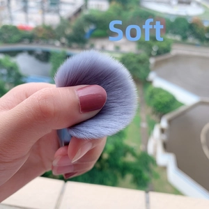 Close-up of soft purple fiber makeup brush bristles being pressed to show plush texture