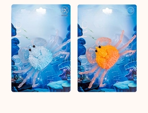 Detail of blue and orange crab stress toys in blister packaging for sea world theme