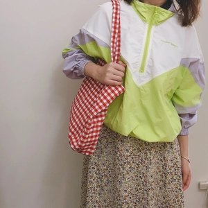 Detail of red and white checkered tote bag paired with a retro French style outfit