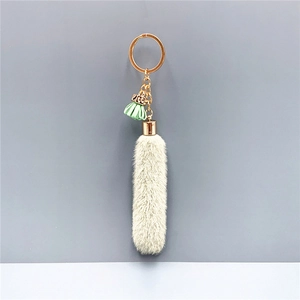 Gray faux fur tassel keychain with mint green fringe and golden hardware accessories