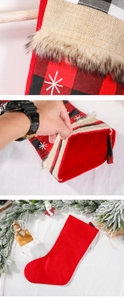 Detail of red and black plaid Christmas stocking with snowflake embroidery and plush cuff