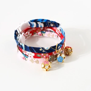Close-up of adjustable pet collars with Japanese floral patterns and golden bells