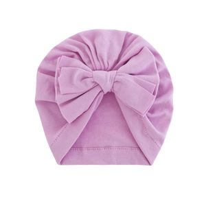 Soft light purple baby turban hat featuring a large knitted bow on a white background