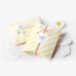 Striped pillow gift boxes in yellow and white with ribbon and thank you tags