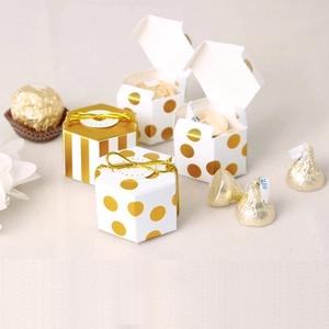 Hexagonal white gift boxes with gold foil dots and stripes, including elastic cords