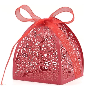 Laser-cut red wedding favor box with intricate rose patterns and a satin ribbon bow