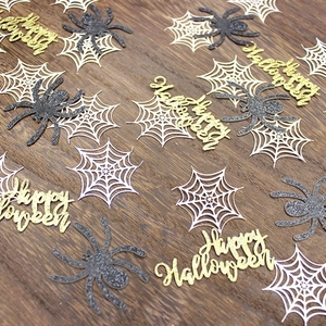 Halloween party confetti with glitter spiders, spider webs and Happy Halloween signs