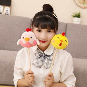 Plush chick massage hammer sticks in pink and yellow with natural wooden handles
